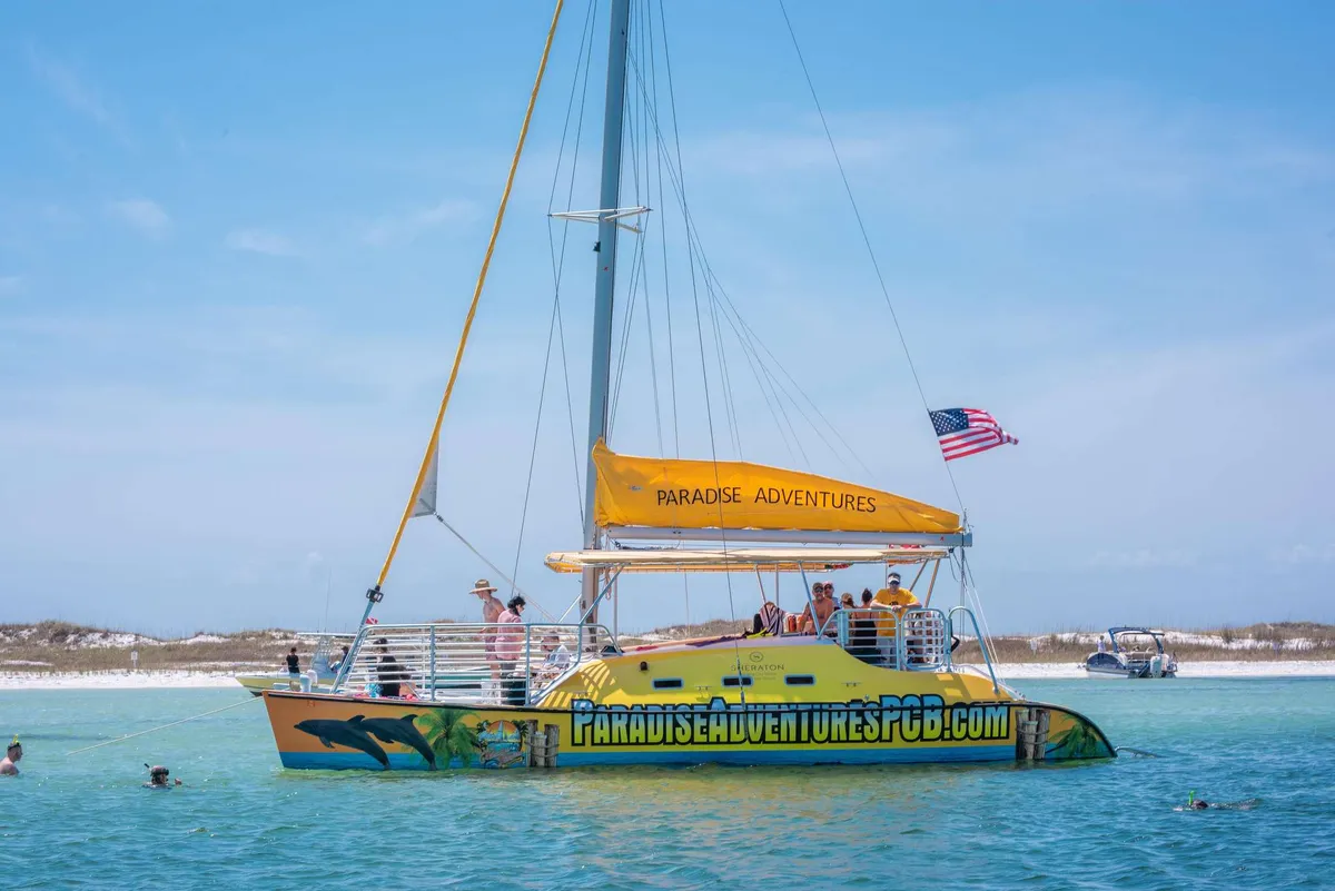 The Footloose catamaran sailing the blue-green Gulf water on a Shell Island Florida snorkeling tour from Panama City Beach
